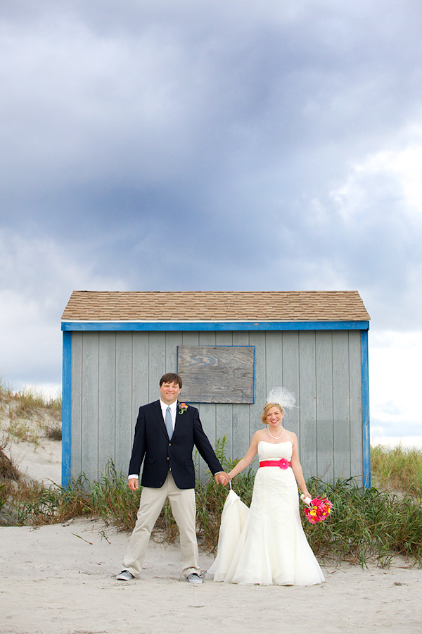 bride and groom pose in front of beach shack - wedding photo by top Philadelphia based wedding photographers Langdon Photography